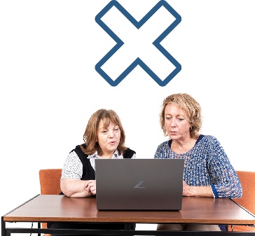 Two people looking at a laptop together. A cross icon.