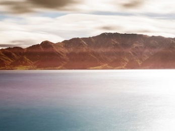 A large lake in front of mountains.