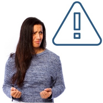 A person looking upset and curling their fingers into their palms. Above them is a danger icon.