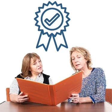 2 people looking at a document together. Above them is a good quality icon.