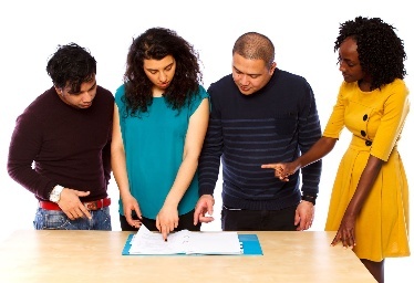 A group of people reading a document together. 
