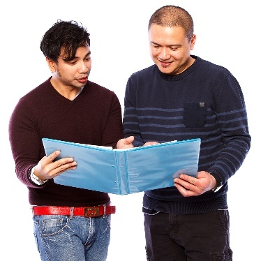 2 people looking at a document together.