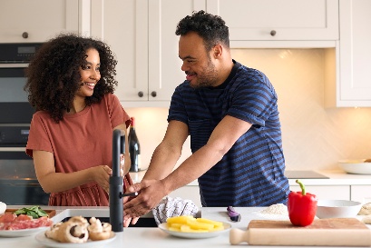 Someone supporting a person to cook.