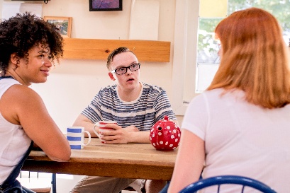 A provider talking to a person and their carer.
