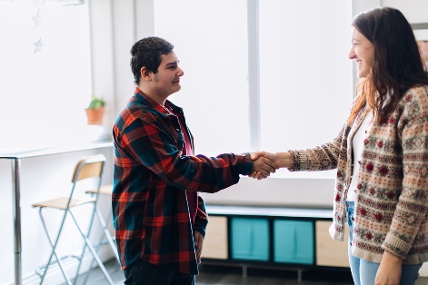 A practitioner shaking hands with a person.