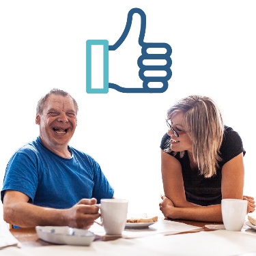 Someone supporting a person who is smiling. There is a thumbs up above them.