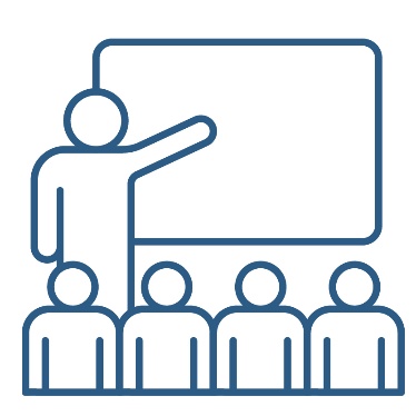 A person presenting to a group of people. They are pointing to a white board.