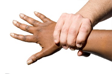 A hand holding the wrist of another person so they cannot move.