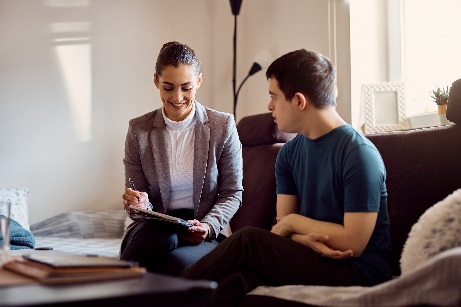 Practitioner looking at a tablet with another person.